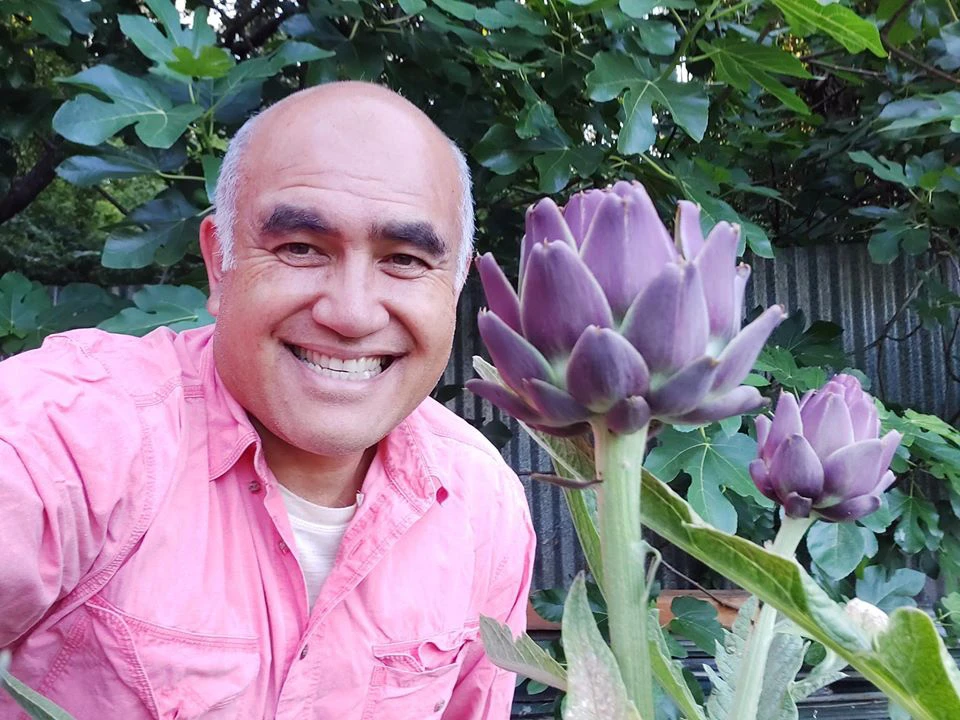 The peaceful life of a man in a small house and a garden full of green vegetables, sweet fruits